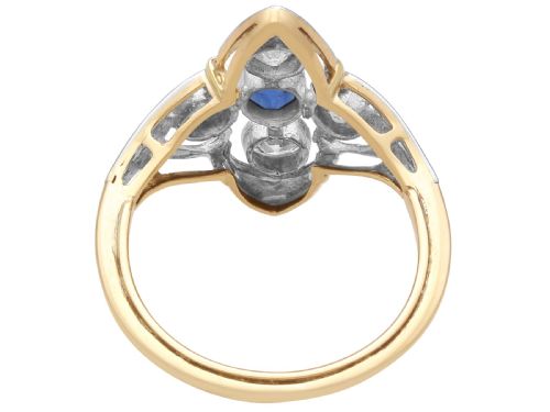 fig 7. An Art Deco 14ct yellow gold ring featuring a central oval blue sapphire surrounded by four round diamonds set in a diamond-shaped openwork frame.