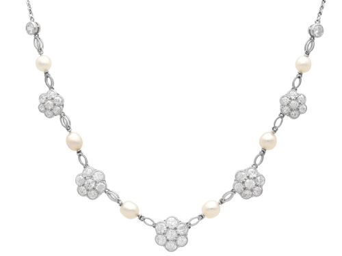 fig 7. An Edwardian platinum chain necklace set with diamond floral clusters and interspersed with round white pearls.