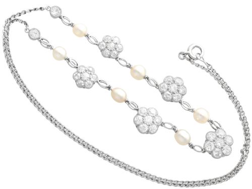 fig 8. An Edwardian platinum chain necklace set with diamond floral clusters and interspersed with round white pearls.