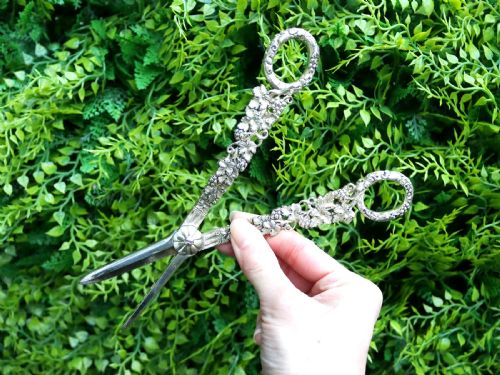 fig 2. A pair of Victorian sterling silver gilt grape shears featuring cast grapevine and leaf motifs along the handles.
