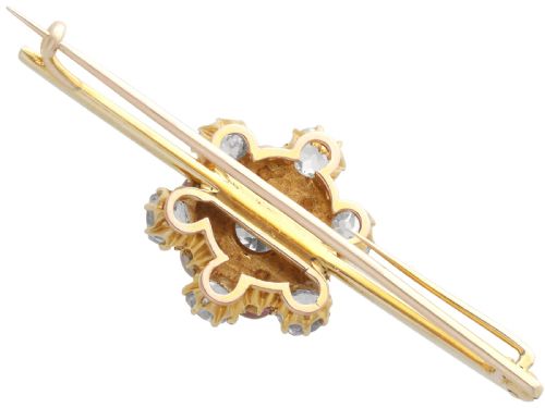 fig 8. An antique 15ct yellow gold bar brooch featuring a central floral cluster set with dark pearls and old-cut diamonds.