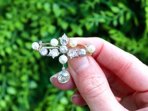 fig 1. An Edwardian 9ct yellow gold brooch featuring old cut diamonds, pearls, and a central drop pendant.