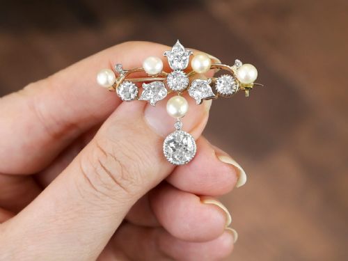 fig 2. An Edwardian 9ct yellow gold brooch featuring old cut diamonds, pearls, and a central drop pendant.
