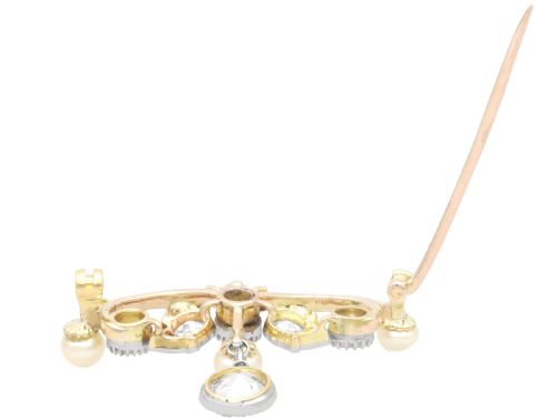fig 9. An Edwardian 9ct yellow gold brooch featuring old cut diamonds, pearls, and a central drop pendant.