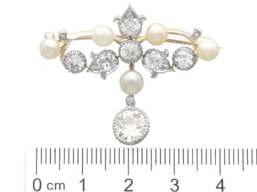 fig 10. An Edwardian 9ct yellow gold brooch featuring old cut diamonds, pearls, and a central drop pendant.