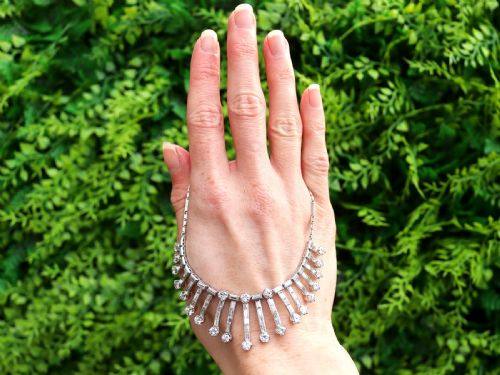 fig 1. An Art Deco platinum fringe necklace set with baguette and round cut diamonds arranged in a geometric drop pattern.