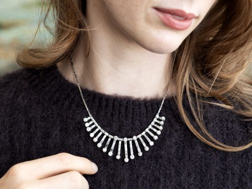 fig 2. An Art Deco platinum fringe necklace set with baguette and round cut diamonds arranged in a geometric drop pattern.