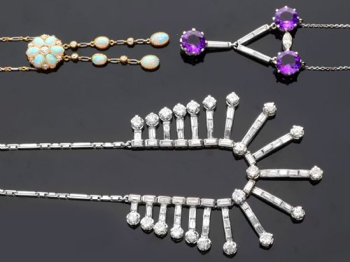 fig 4. An Art Deco platinum fringe necklace set with baguette and round cut diamonds arranged in a geometric drop pattern.