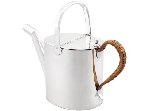 fig 5. An Edwardian sterling silver watering can featuring a cylindrical body, straight spout, overhead loop handle, woven cane side handle, and an engraved central monogram.