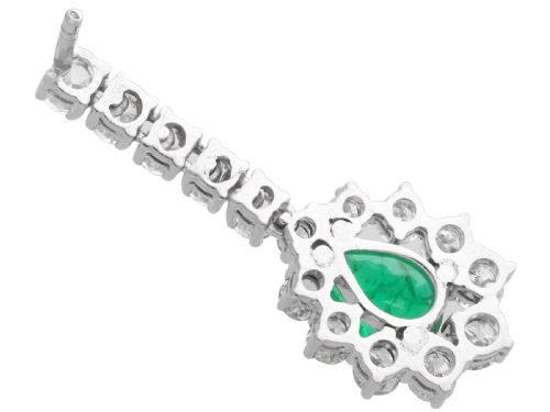 fig 5. A pair of 18ct white gold drop earrings featuring pear-cut green emeralds surrounded by round diamond halos suspended from vertical diamond bars.