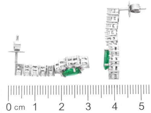 fig 7. A pair of 18ct white gold drop earrings featuring pear-cut green emeralds surrounded by round diamond halos suspended from vertical diamond bars.