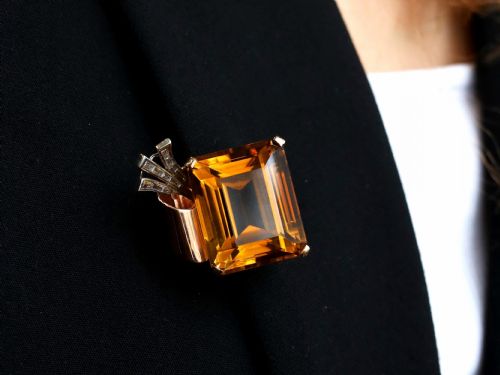 fig 3. A large emerald-cut amber citrine stone set in a 14ct yellow gold brooch mounting accented with baguette diamonds.