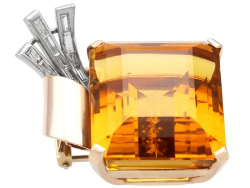 fig 5. A large emerald-cut amber citrine stone set in a 14ct yellow gold brooch mounting accented with baguette diamonds.