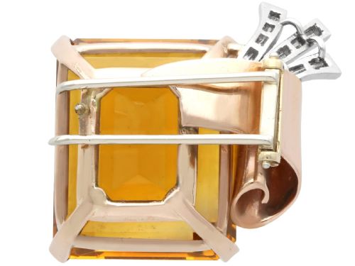 fig 6. A large emerald-cut amber citrine stone set in a 14ct yellow gold brooch mounting accented with baguette diamonds.