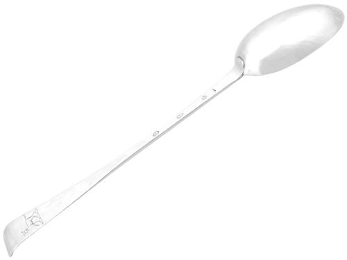 fig 3. An antique George II Irish sterling silver hash spoon featuring an elongated oval bowl and a long stem with an upturned terminal.