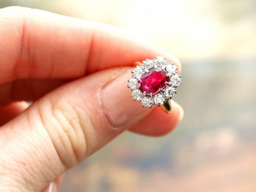 fig 3. An antique 18ct yellow gold ring featuring a central oval red ruby set within a cluster halo of round white diamonds.