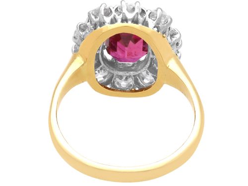 fig 6. An antique 18ct yellow gold ring featuring a central oval red ruby set within a cluster halo of round white diamonds.
