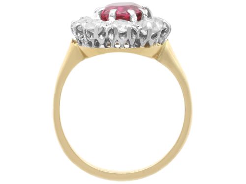 fig 7. An antique 18ct yellow gold ring featuring a central oval red ruby set within a cluster halo of round white diamonds.