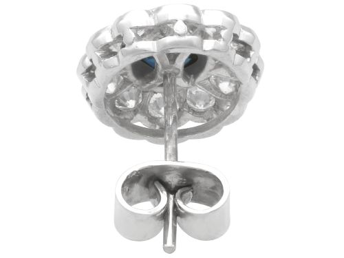 fig 7. Pair of 1930s 18ct white gold cluster earrings featuring oval blue sapphire centerpieces framed by halos of round diamonds.