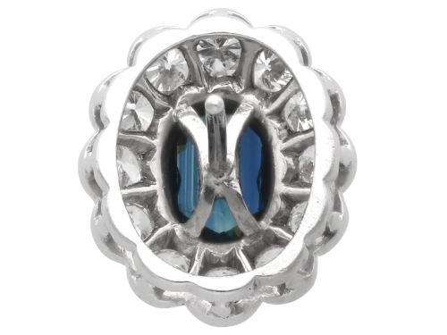 fig 9. Pair of 1930s 18ct white gold cluster earrings featuring oval blue sapphire centerpieces framed by halos of round diamonds.