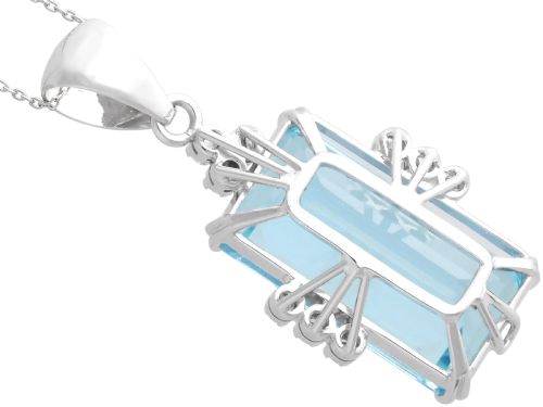 fig 8. A vintage 18ct white gold pendant featuring a large emerald-cut light blue aquamarine framed by accent diamonds, suspended from an engraved bail.