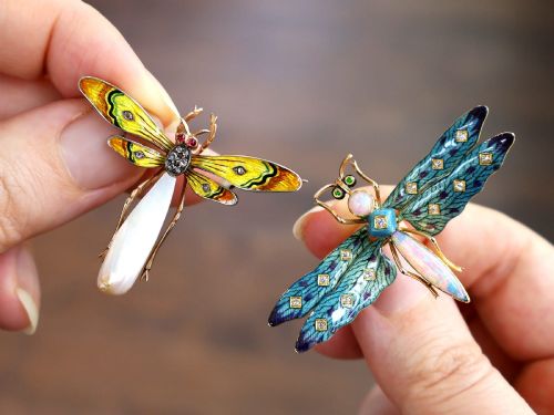 fig 4. An antique late Victorian dragonfly brooch crafted in yellow gold with yellow enamel wings, garnet eyes, rose-cut diamond accents, and a elongated natural pearl abdomen.