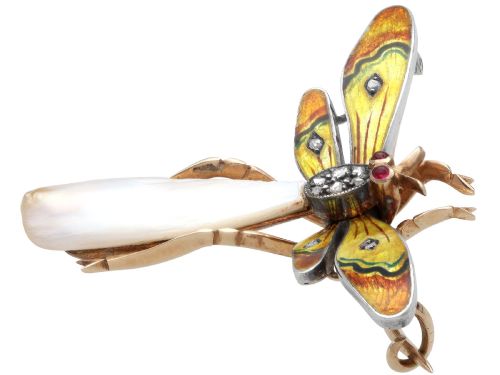 fig 6. An antique late Victorian dragonfly brooch crafted in yellow gold with yellow enamel wings, garnet eyes, rose-cut diamond accents, and a elongated natural pearl abdomen.