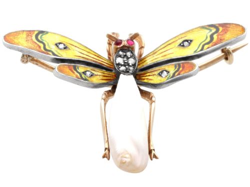 fig 7. An antique late Victorian dragonfly brooch crafted in yellow gold with yellow enamel wings, garnet eyes, rose-cut diamond accents, and a elongated natural pearl abdomen.