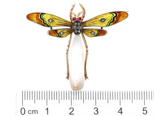 fig 10. An antique late Victorian dragonfly brooch crafted in yellow gold with yellow enamel wings, garnet eyes, rose-cut diamond accents, and a elongated natural pearl abdomen.