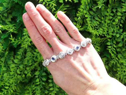 fig 1. A vintage 18ct white gold articulated link bracelet set with alternating bezel-mounted round diamonds and blue sapphires.