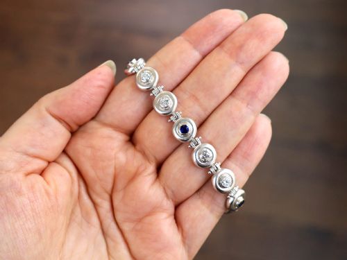 fig 3. A vintage 18ct white gold articulated link bracelet set with alternating bezel-mounted round diamonds and blue sapphires.