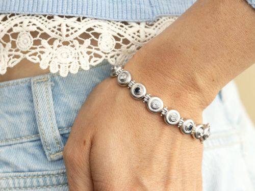 fig 4. A vintage 18ct white gold articulated link bracelet set with alternating bezel-mounted round diamonds and blue sapphires.