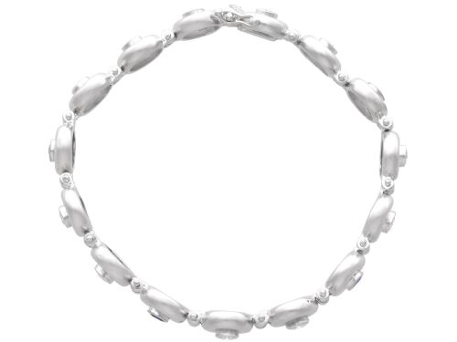 fig 5. A vintage 18ct white gold articulated link bracelet set with alternating bezel-mounted round diamonds and blue sapphires.