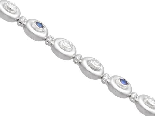 fig 6. A vintage 18ct white gold articulated link bracelet set with alternating bezel-mounted round diamonds and blue sapphires.