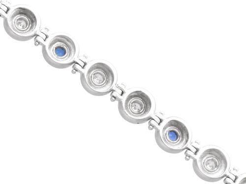fig 7. A vintage 18ct white gold articulated link bracelet set with alternating bezel-mounted round diamonds and blue sapphires.