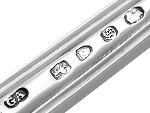 fig 11. A collection of ornate sterling silver cutlery pieces featuring intricately embossed handles and polished bowls, including ladles, forks, knives, and spoons.