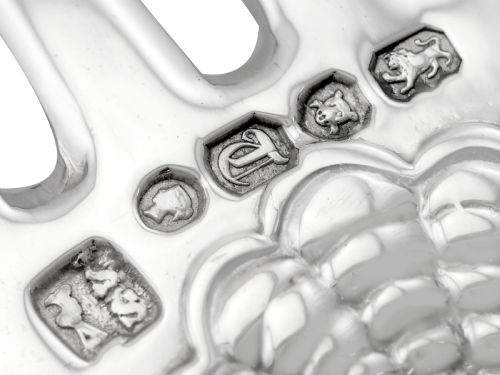 fig 12. A collection of ornate sterling silver cutlery pieces featuring intricately embossed handles and polished bowls, including ladles, forks, knives, and spoons.