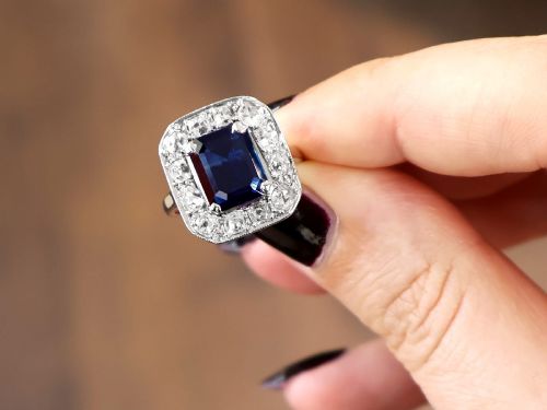 fig 5. An Art Deco platinum cluster ring featuring a central rectangular blue sapphire surrounded by twelve old-cut diamonds with millegrain edges.