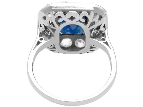 fig 7. An Art Deco platinum cluster ring featuring a central rectangular blue sapphire surrounded by twelve old-cut diamonds with millegrain edges.