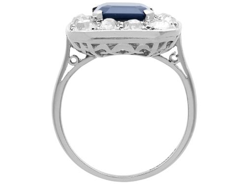 fig 8. An Art Deco platinum cluster ring featuring a central rectangular blue sapphire surrounded by twelve old-cut diamonds with millegrain edges.
