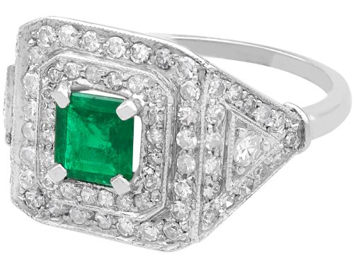 fig 4. An Art Deco platinum ring featuring a central square green emerald surrounded by geometric concentric halos of brilliant-cut diamonds.