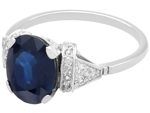 fig 3. An Art Deco platinum ring featuring a centrally set oval blue sapphire flanked by diamond-set geometric shoulders.