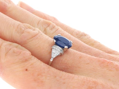 fig 8. An Art Deco platinum ring featuring a centrally set oval blue sapphire flanked by diamond-set geometric shoulders.