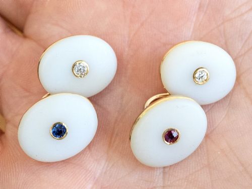 fig 2. Four oval 15ct yellow gold cufflinks featuring smooth white agate faces with central bezel-set diamond, sapphire, and ruby gemstones.