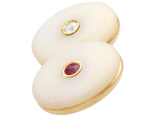 fig 7. Four oval 15ct yellow gold cufflinks featuring smooth white agate faces with central bezel-set diamond, sapphire, and ruby gemstones.