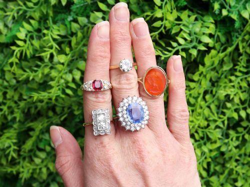 fig 2. A vintage 14ct white gold cluster ring featuring a centrally mounted cushion-cut blue Ceylon sapphire surrounded by a double halo of round brilliant diamonds.