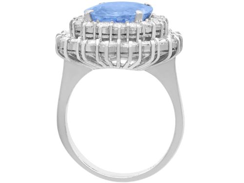 fig 7. A vintage 14ct white gold cluster ring featuring a centrally mounted cushion-cut blue Ceylon sapphire surrounded by a double halo of round brilliant diamonds.