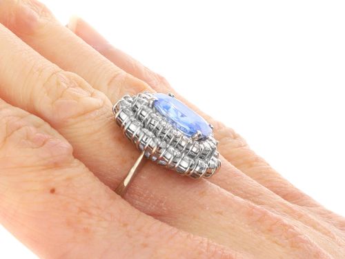 fig 9. A vintage 14ct white gold cluster ring featuring a centrally mounted cushion-cut blue Ceylon sapphire surrounded by a double halo of round brilliant diamonds.