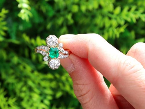 fig 1. An antique 18ct yellow gold twist ring set with a central green emerald, flanked by two old cut diamonds and diamond-set shoulders.