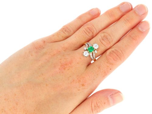 fig 10. An antique 18ct yellow gold twist ring set with a central green emerald, flanked by two old cut diamonds and diamond-set shoulders.